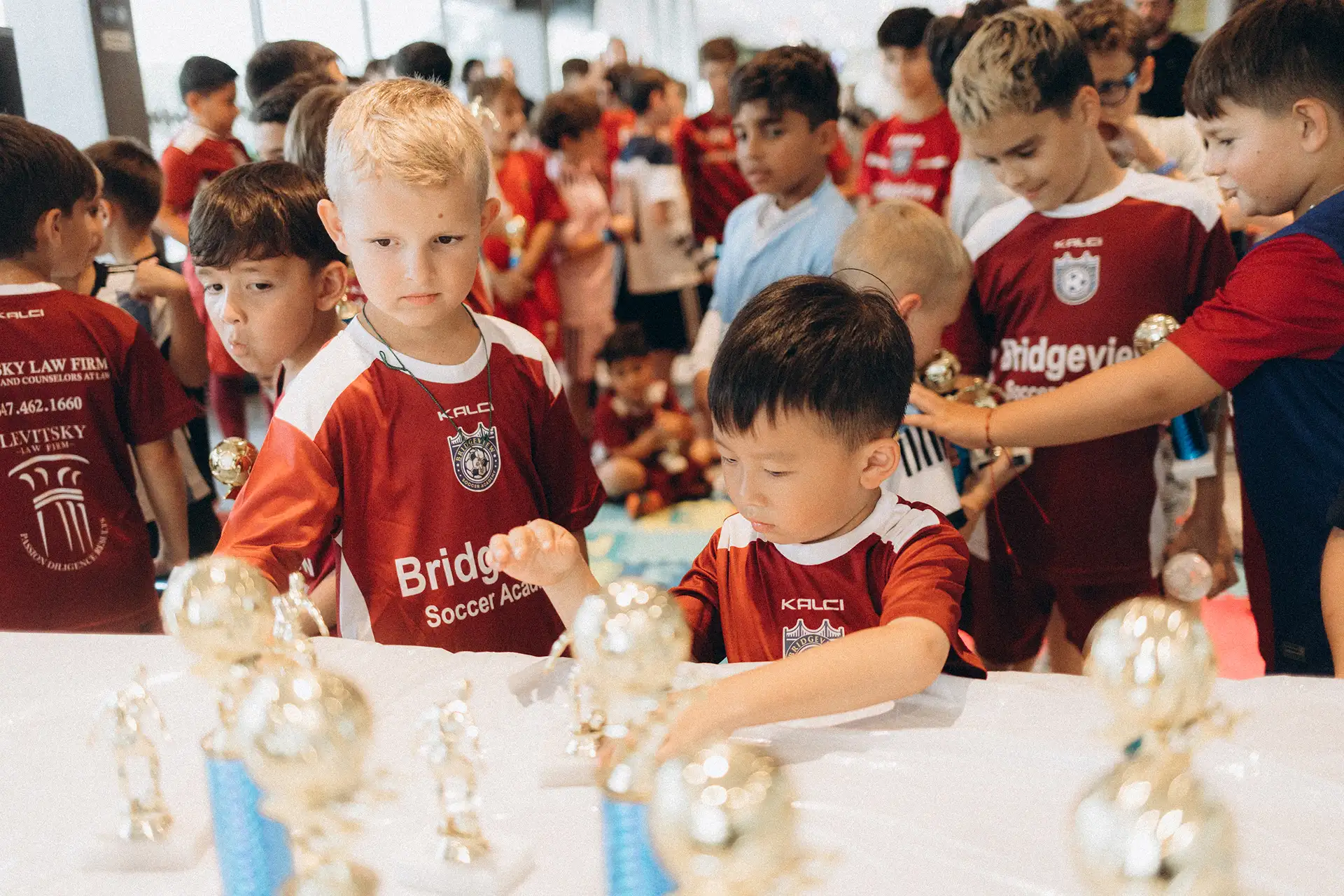 Kids celebrating with their trophies at Bridgeview